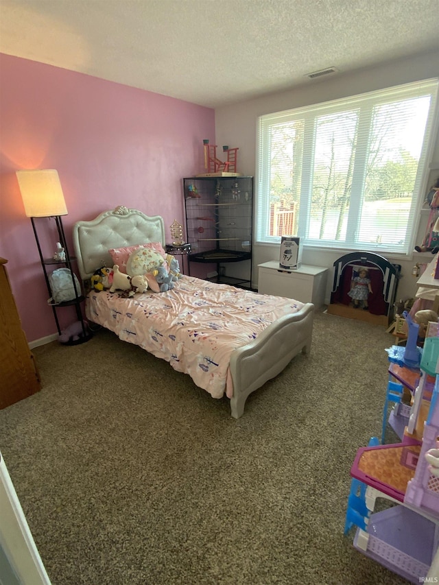 carpeted bedroom with a textured ceiling and visible vents