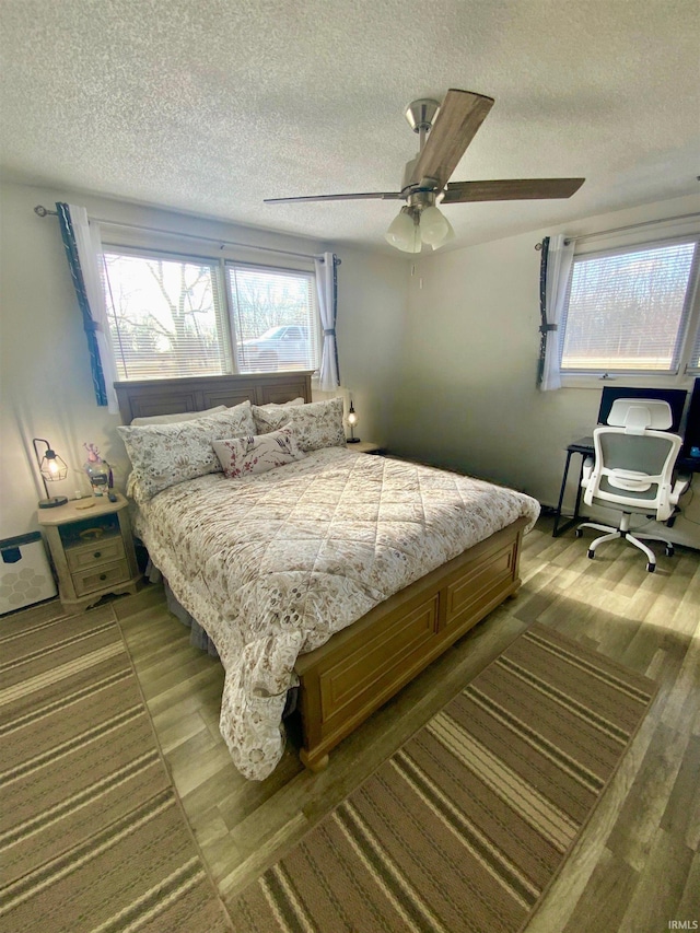 bedroom featuring a ceiling fan and a textured ceiling