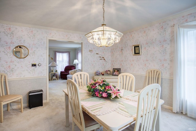 dining space featuring ornamental molding, light colored carpet, and wallpapered walls