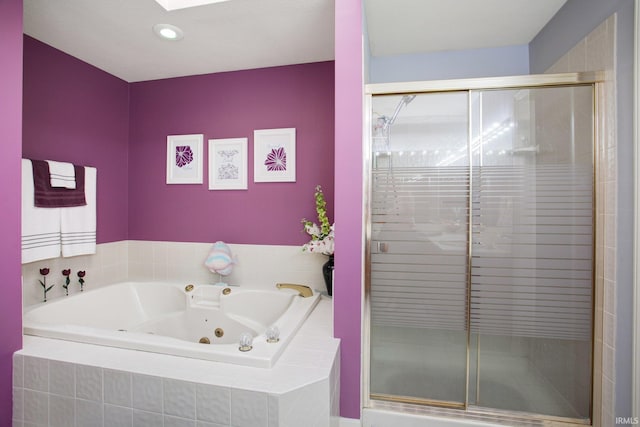 bathroom featuring a stall shower and a tub with jets