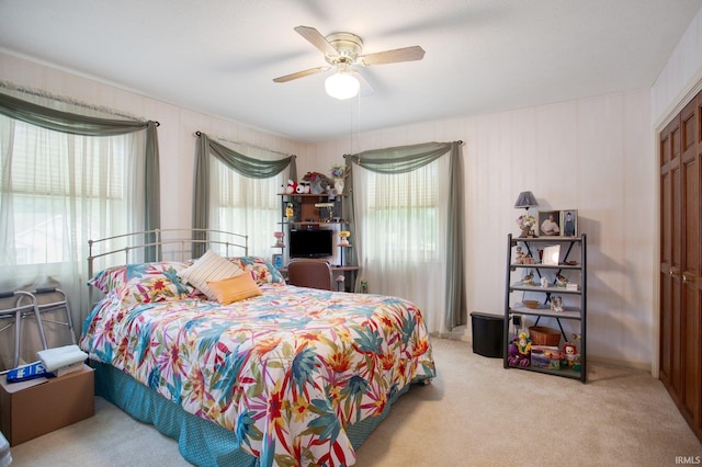 bedroom featuring light carpet and ceiling fan