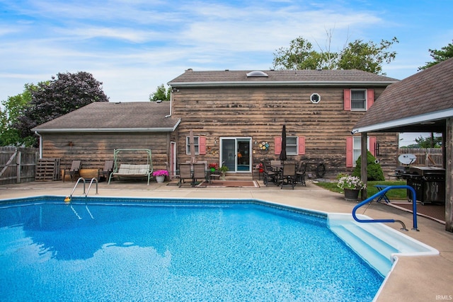 view of swimming pool with a fenced in pool, a patio, and fence