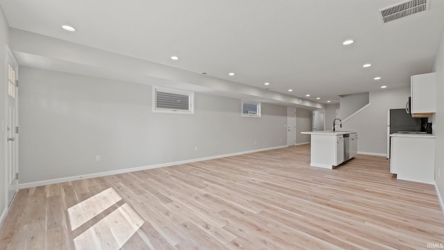 unfurnished living room featuring light wood-style floors, recessed lighting, visible vents, and baseboards