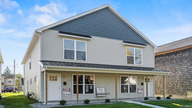 view of front of house with metal roof, a porch, and a standing seam roof