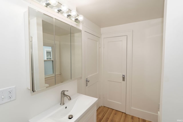 bathroom with wood finished floors and vanity