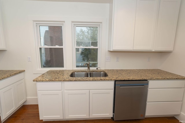 kitchen featuring light stone counters, dark wood-type flooring, a sink, white cabinets, and dishwasher