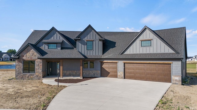 view of front facade with a shingled roof, driveway, and board and batten siding