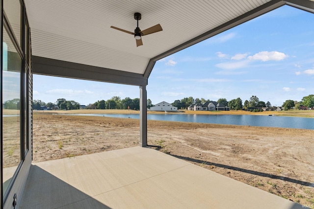 view of patio with a ceiling fan and a water view