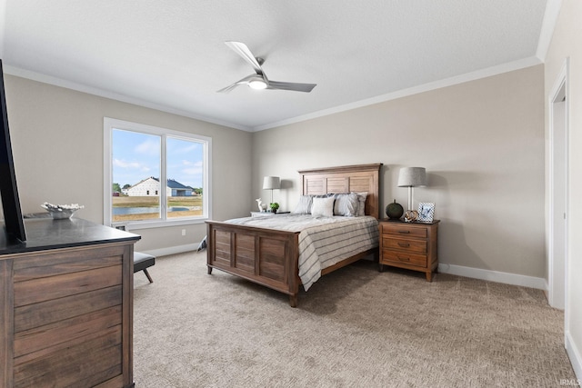 bedroom featuring ceiling fan, baseboards, crown molding, and light colored carpet