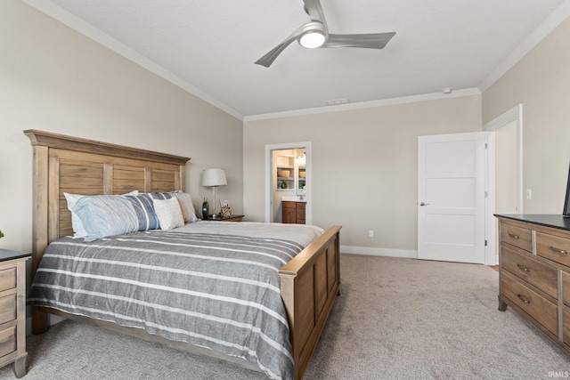 bedroom with ornamental molding, light colored carpet, baseboards, and ensuite bathroom