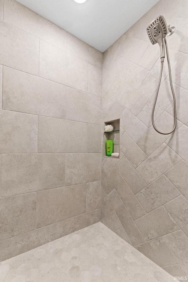 bathroom with a tile shower