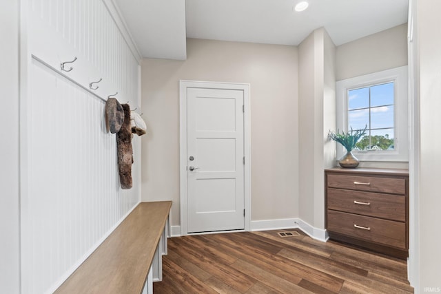 mudroom with visible vents, baseboards, and dark wood finished floors