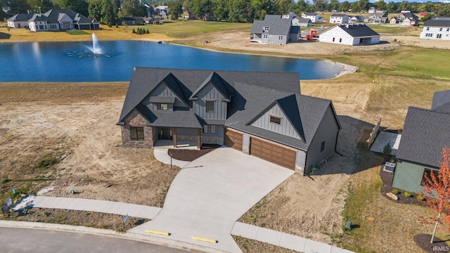 bird's eye view featuring a residential view and a water view