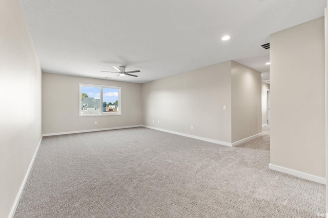 carpeted empty room featuring baseboards, a ceiling fan, and recessed lighting