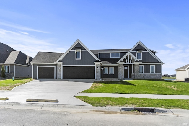 view of front facade featuring driveway, stone siding, and a front yard