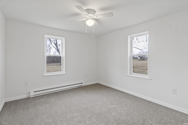 carpeted spare room with a ceiling fan, baseboards, and baseboard heating