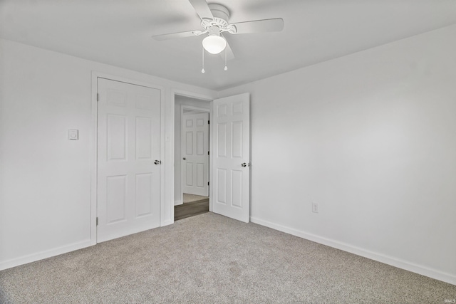 unfurnished bedroom featuring ceiling fan, carpet flooring, and baseboards