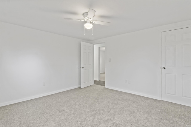 unfurnished bedroom featuring carpet, ceiling fan, and baseboards