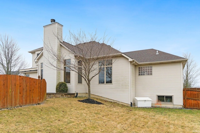 view of property exterior with a chimney, fence, a lawn, and roof with shingles