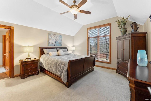 bedroom featuring light carpet, ceiling fan, baseboards, and lofted ceiling