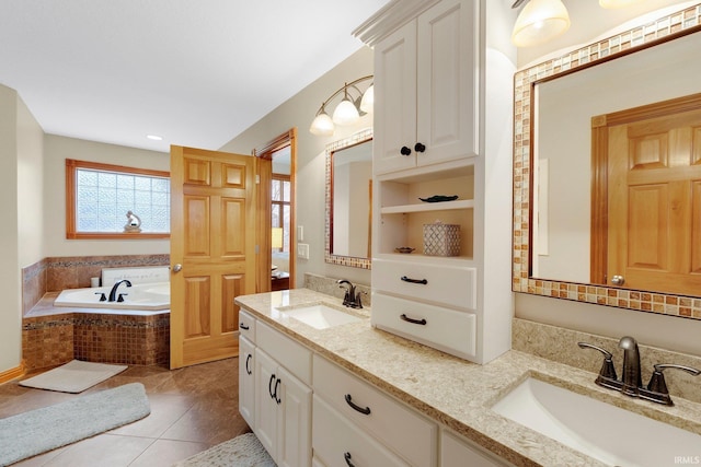 bathroom with tile patterned flooring, a sink, a bath, and double vanity