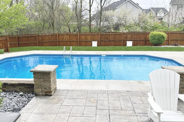 view of pool with a patio area, a fenced backyard, a fenced in pool, and a yard