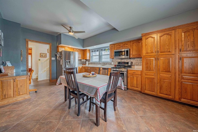 dining area with ceiling fan and tile patterned floors