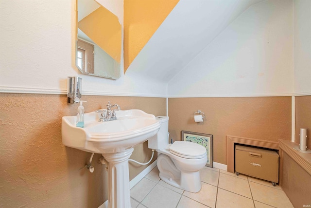 bathroom featuring vaulted ceiling, toilet, and tile patterned floors