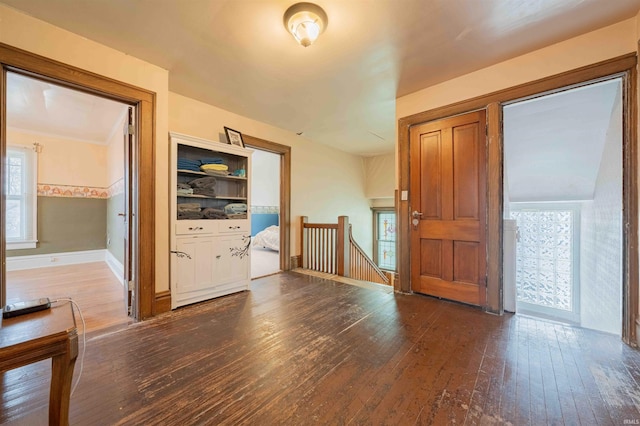 interior space featuring wood-type flooring and baseboards