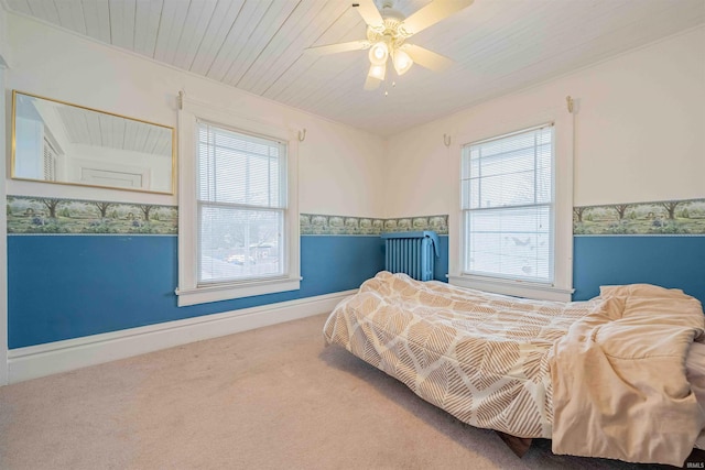 bedroom featuring wooden ceiling, multiple windows, baseboards, and carpet flooring