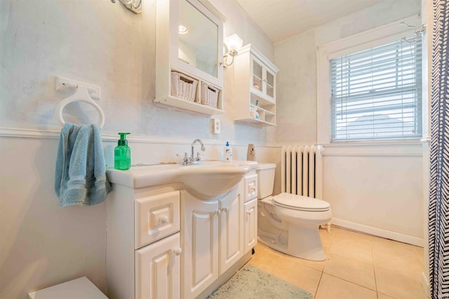 bathroom featuring toilet, vanity, radiator heating unit, and tile patterned floors