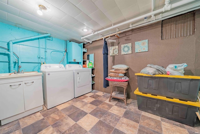 laundry area featuring washer and clothes dryer and a sink