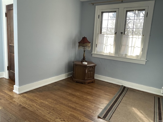 interior space with dark wood finished floors and baseboards