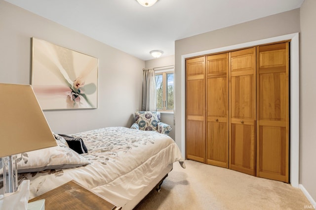 bedroom with a closet and light carpet