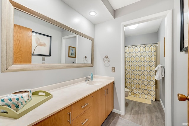 full bath featuring a shower with shower curtain, vanity, toilet, and wood finished floors