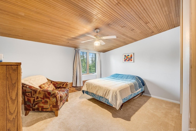 carpeted bedroom featuring vaulted ceiling, ceiling fan, wooden ceiling, and baseboards