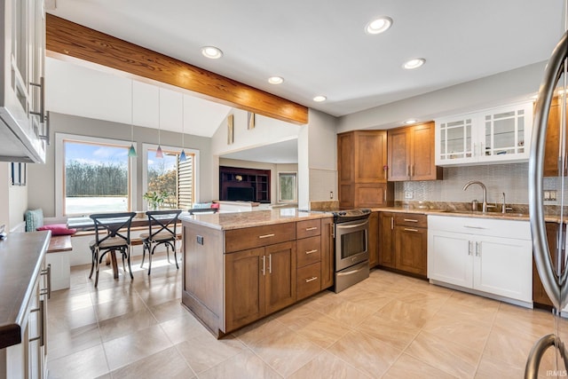 kitchen with light stone counters, appliances with stainless steel finishes, brown cabinetry, glass insert cabinets, and white cabinets