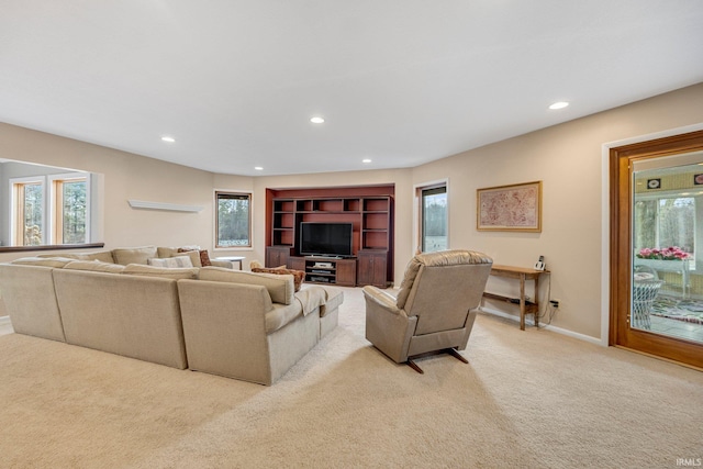 living room with recessed lighting, light colored carpet, and baseboards