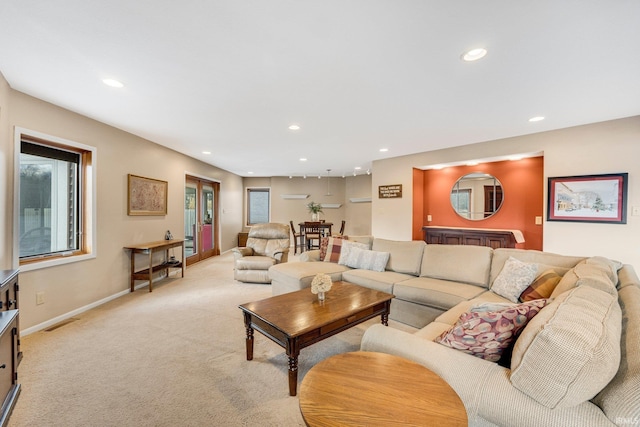 living area with light carpet, baseboards, visible vents, and recessed lighting