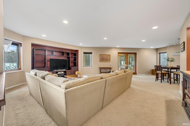 living room featuring baseboards, recessed lighting, and light colored carpet