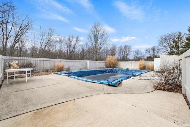 view of swimming pool with a fenced backyard, a fenced in pool, and a patio