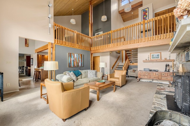 carpeted living room with a towering ceiling and stairway