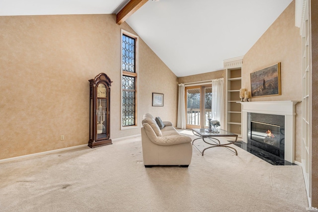 carpeted living area with baseboards, a fireplace with flush hearth, high vaulted ceiling, and beam ceiling