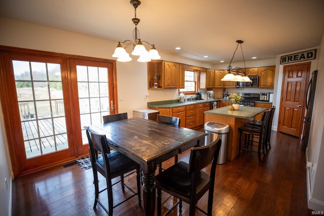 dining room with an inviting chandelier, dark wood-style flooring, and recessed lighting