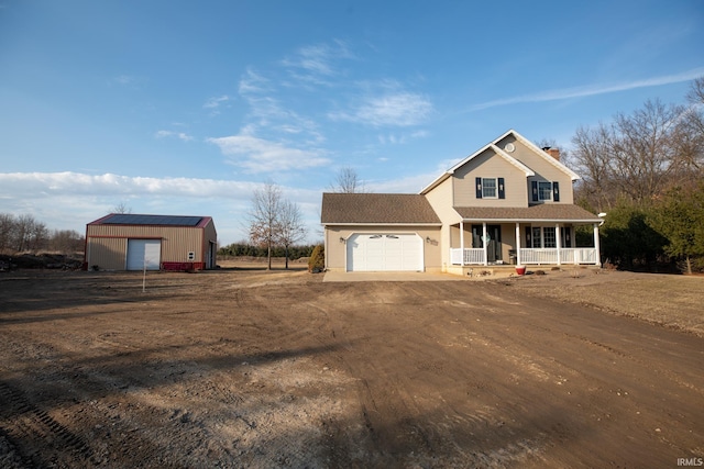 view of front of house with a chimney, a shingled roof, covered porch, an attached garage, and driveway