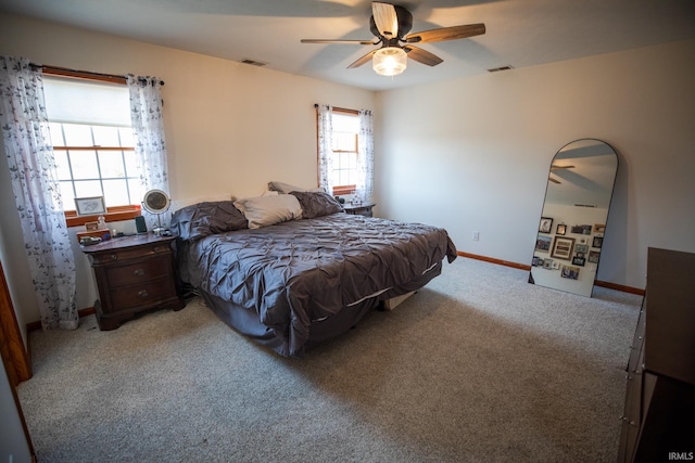 bedroom featuring light carpet, baseboards, visible vents, and ceiling fan