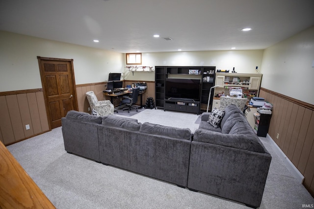 carpeted living area with recessed lighting, wainscoting, and wood walls