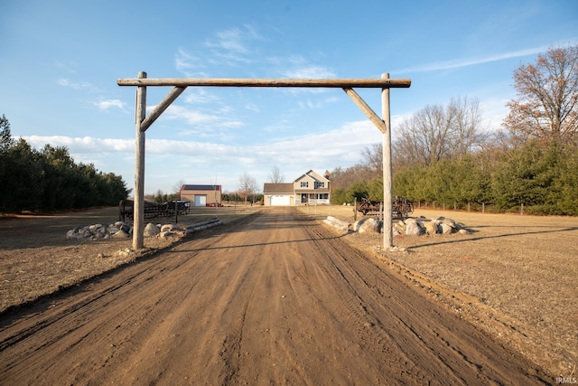 view of street with a rural view and driveway