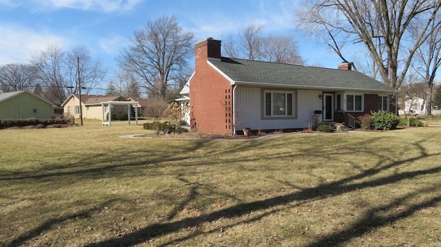 exterior space featuring a chimney and a front lawn