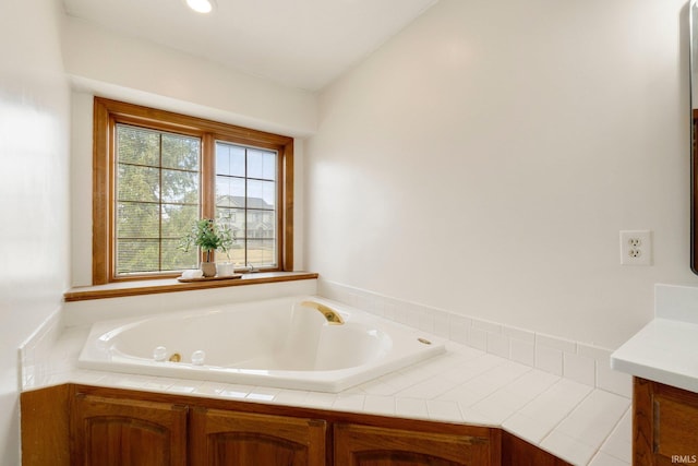 bathroom featuring vanity and a bath